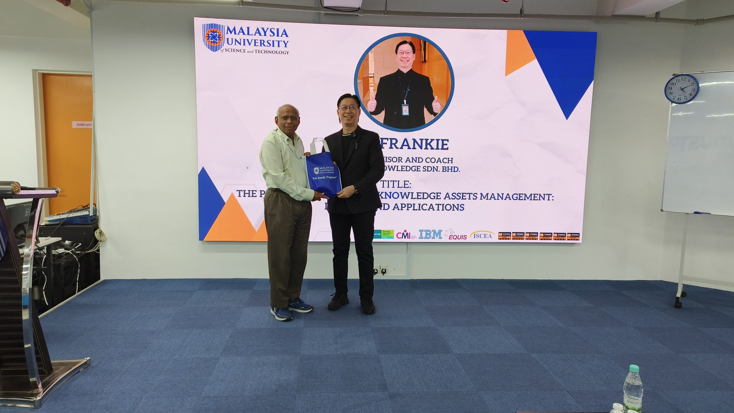 Dr Frankie received gift presented by Professor of Malaysia University of Science and Technology MUST